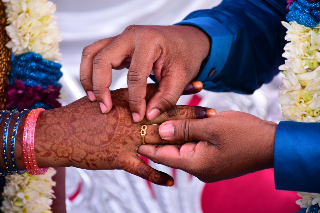 Ring exchange ceremony with traditional mehndi and bangles